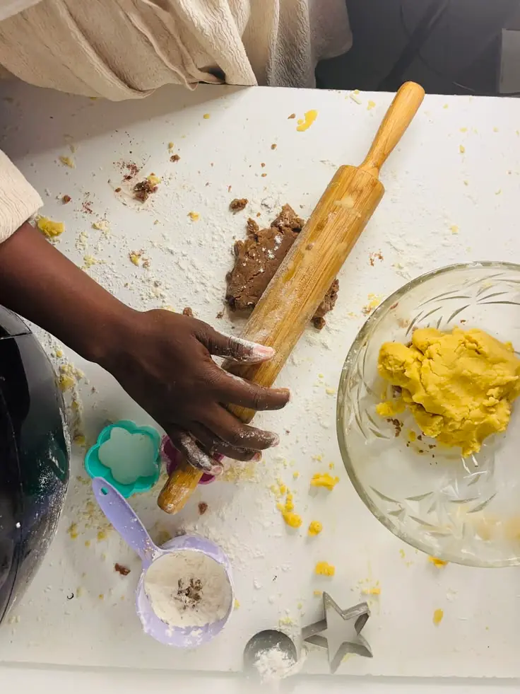 Rolling out biscuit dough on a floured table